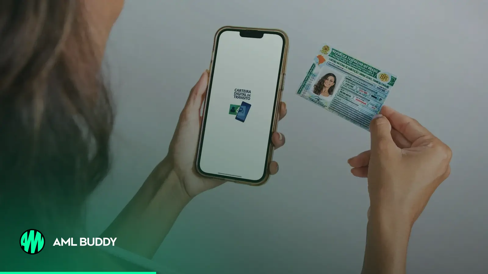 Hands holding a photo ID card next to a smartphone
