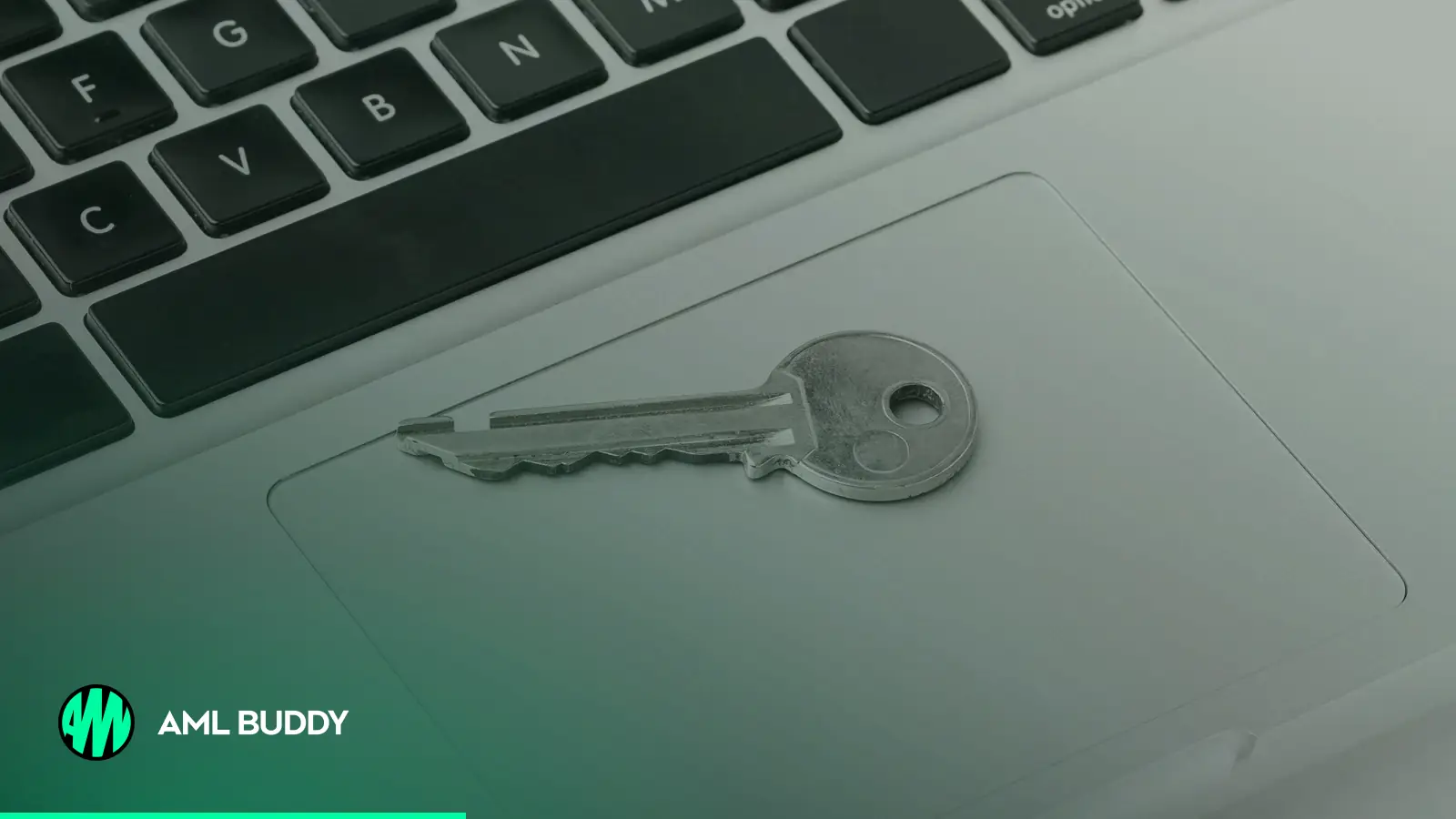 A house key resting on a laptop keyboard