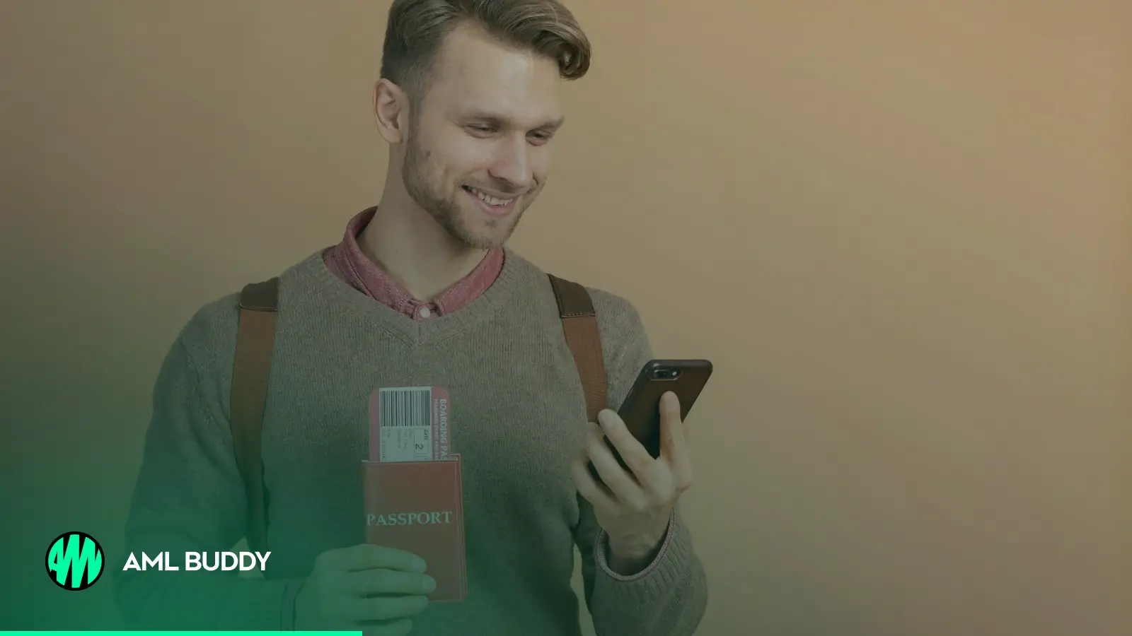 A man holding his passport and checking his smartphone